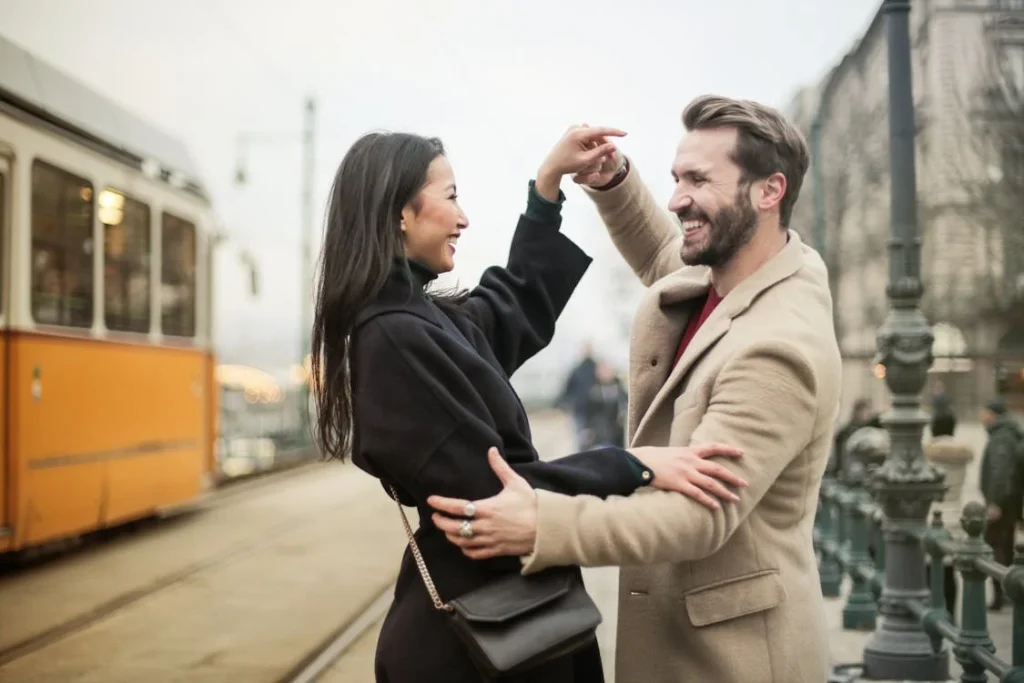Couple dancing near city tram tracks