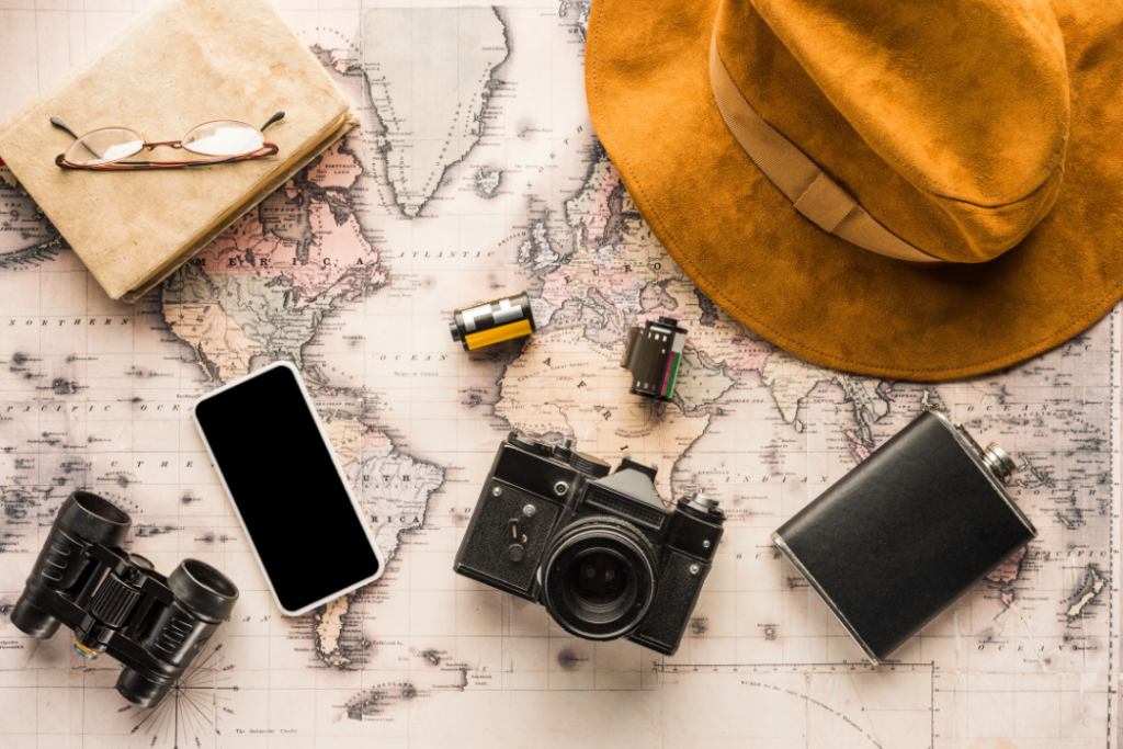Travel essentials on vintage world map