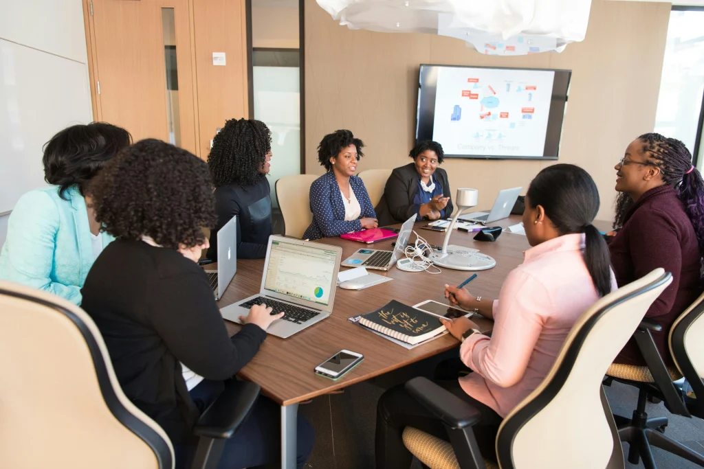 Diverse group in a business meeting with laptops.