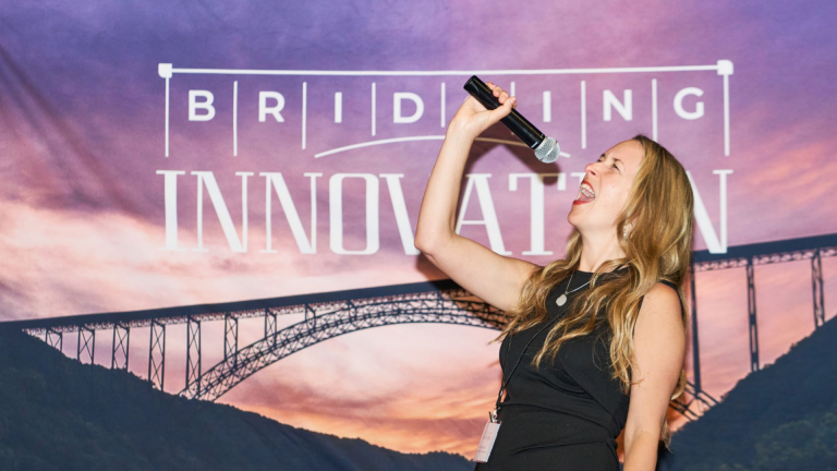 Dina Colada speaking on AI strategies at Bridging Innovations conference, West Virginia